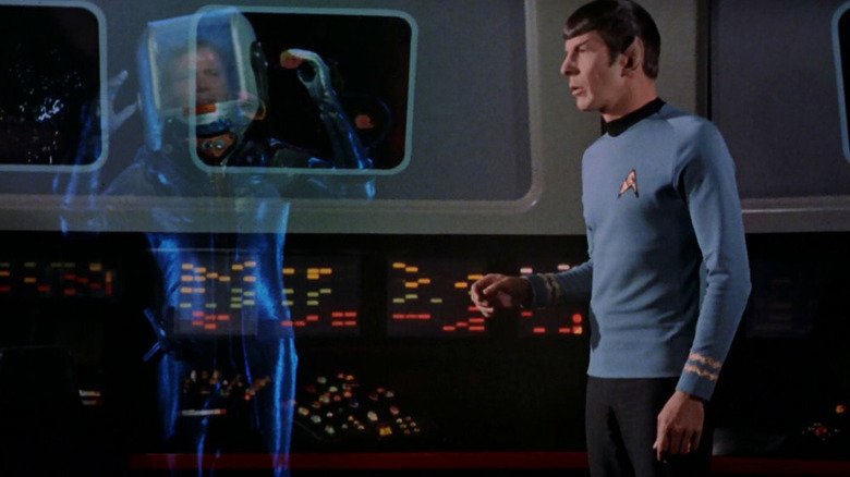 Spock is looking at transparent Captain Kirk on Star Trek