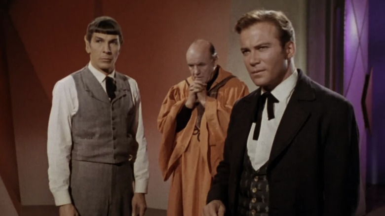 Spock in a waistcoat and tie next to Marplon and Kirk