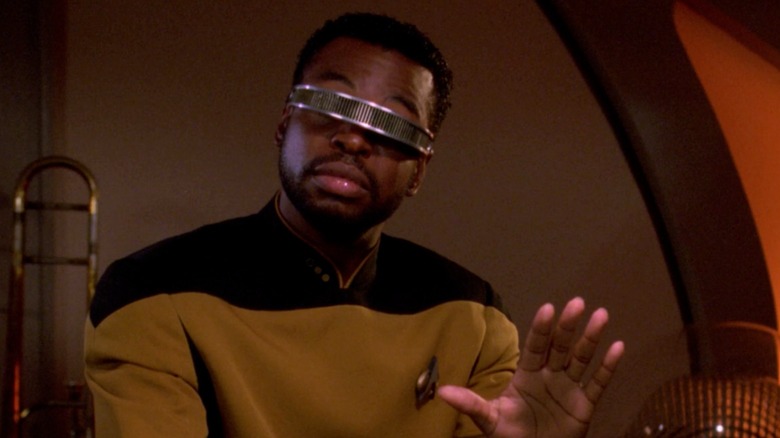 Geordi La Forge holds out hand