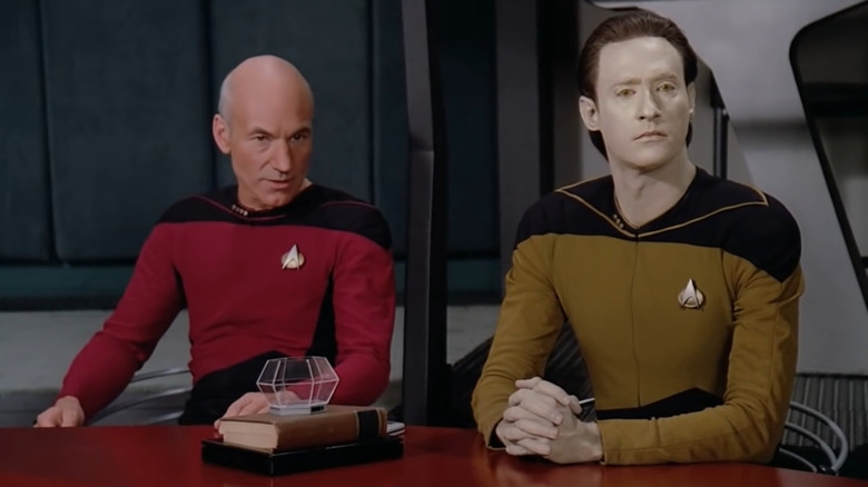 Picard and Data sitting behind table