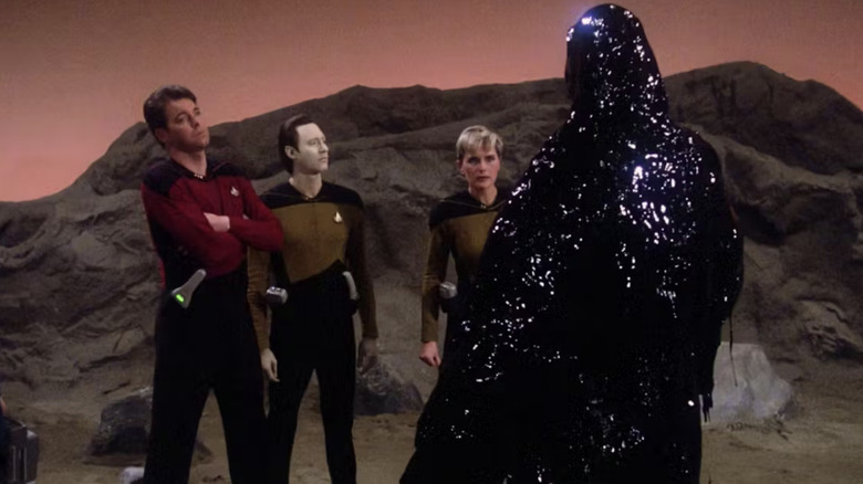 Armus stands before Riker, Data, and Troi on "Star Trek: The Next Generation" (1987-1994)