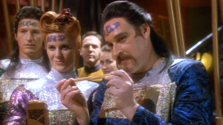 A Waadi holds a small yellow rod in "Star Trek: Deep Space Nine" (1993-1999)