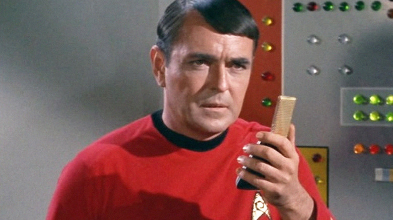 Scotty Holding a Communicator