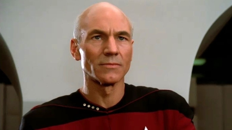 Picard stands in front of a wall