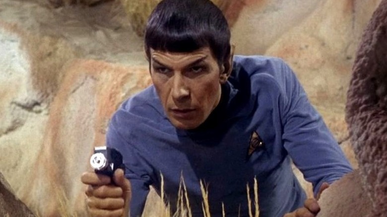 Spock crouches while pointing his phaser in Star Trek: The Original Series (1966)