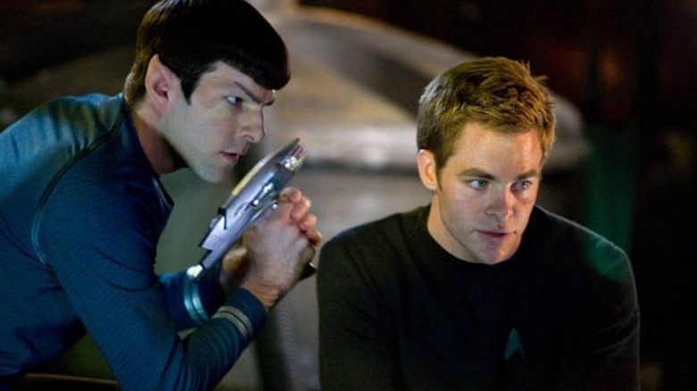 Spock holding a phaser beside Kirk in Star Trek