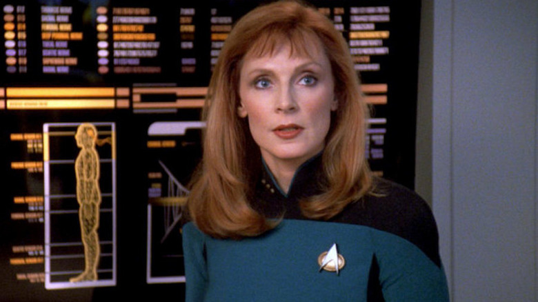 Doctor Crusher stands in front of a display in sickbay in Star Trek: The Next Generation