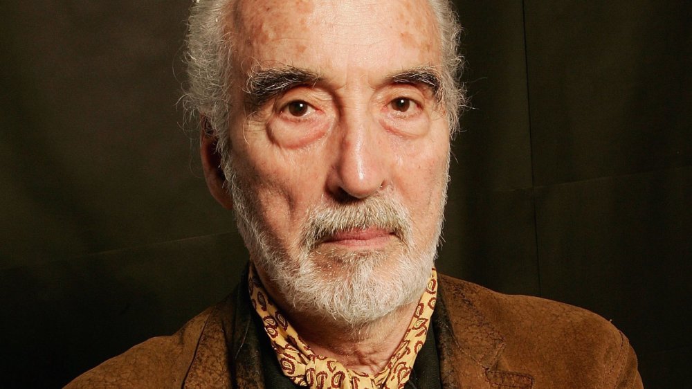 Christopher Lee wearing brown jacket