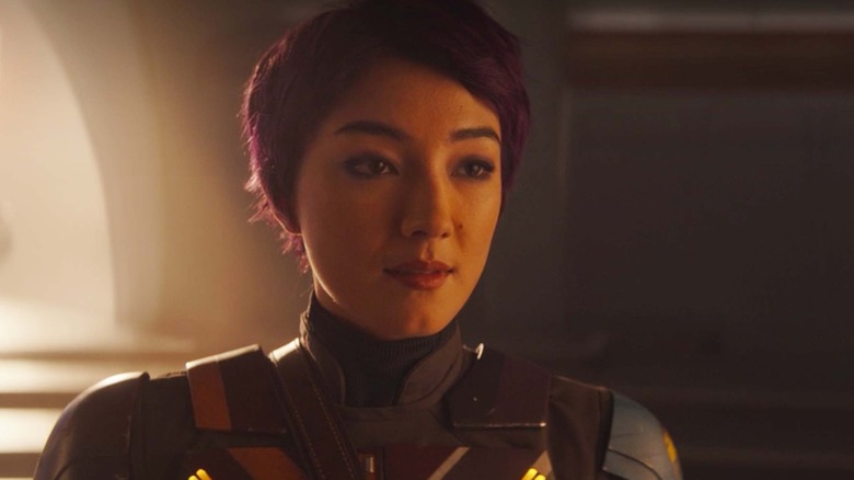 Sabine smiles wearing armor