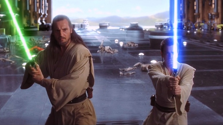 Qui-Gon and Obi-Wan raise their lightsabers