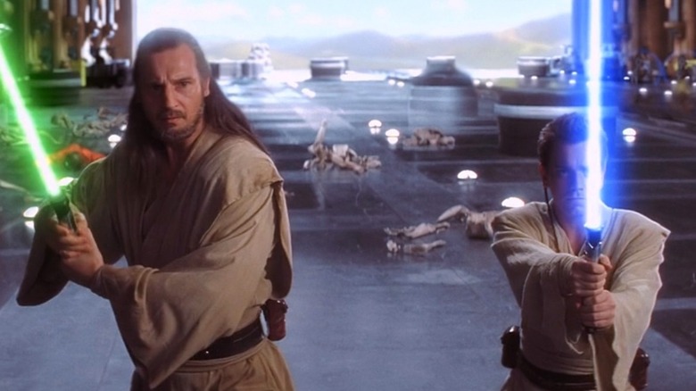 Qui-Gon and Obi-Wan raise their lightsabers