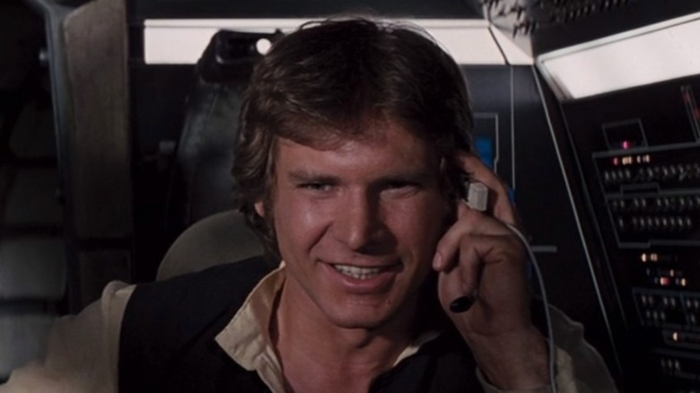 Han Solo talks with Luke Skywalker over his headset