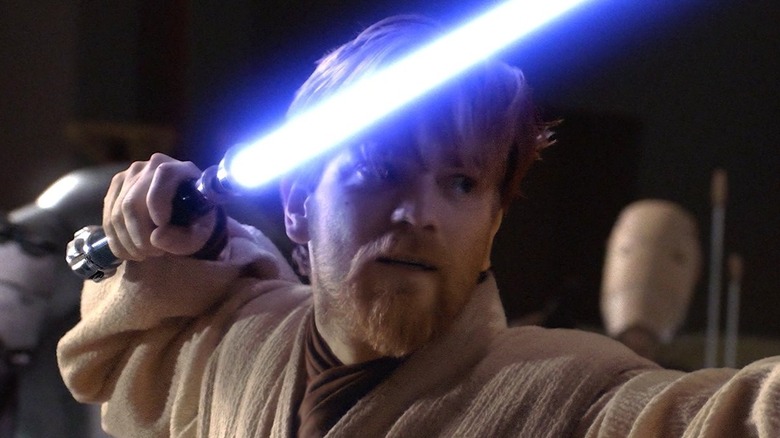 Obi-Wan holding lightsaber near head