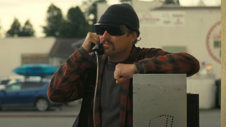 Calhoun talks on a payphone in One Battle After Another