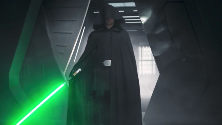 Luke Skywalker holding his lightsaber