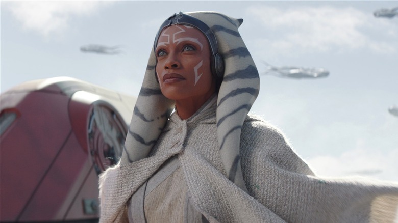 Ahsoka Tano standing on the wing of a starship, looking at a pod of Purrgil, in Ahsoka (2023)