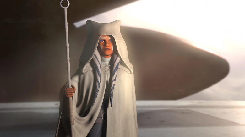 Ahsoka standing with a white robe and staff at the end of Star Wars: Rebels (2018)