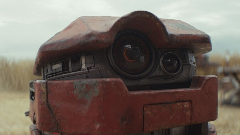 Close-up of B2EMO rolling through a field in Andor season 2 (2025)