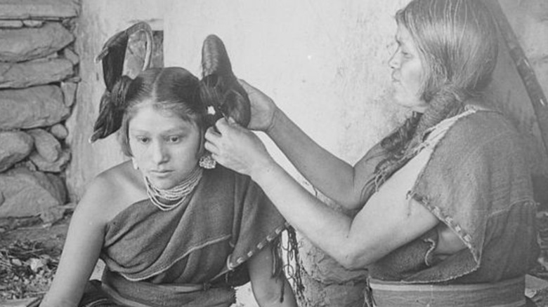 A Hopi woman having her hair done