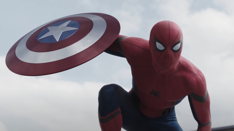 Spider-Man holding Captain America's shield