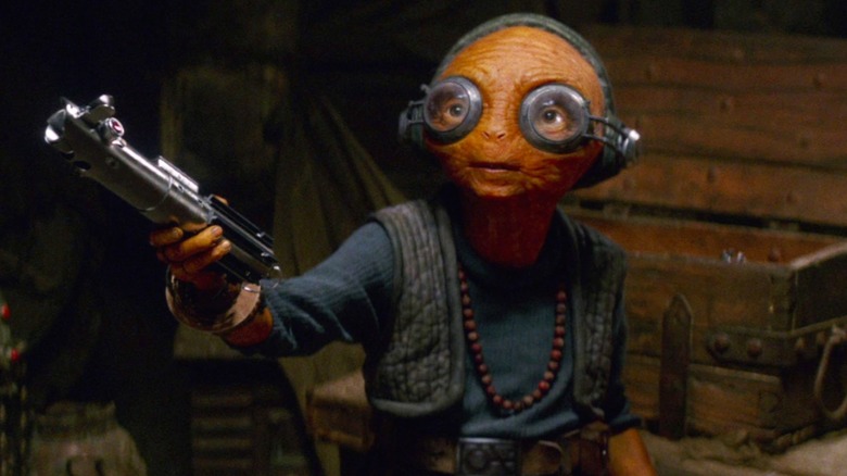 Maz Kanata holding Luke Skywalker's lightsaber