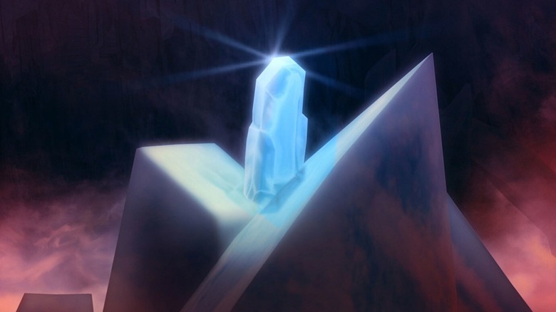 A blue kyber crystal sitting on a rock in "Star Wars: The Clone Wars."