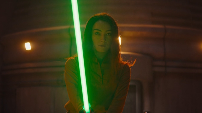 Sabine Wren wielding a green lightsaber at night in Star Wars: Ahsoka (2023)