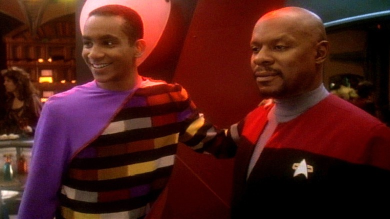 Jake Sisko with his hand on Benjamin Sisko's shoulder in Star Trek: Deep Space Nine