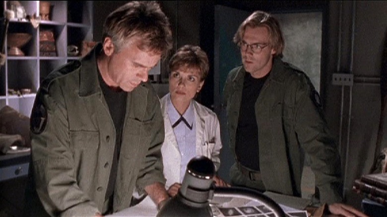 Jack, Daniel, and Carter looking over documents in 