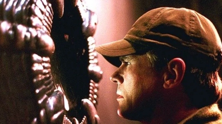O'Neill looking into an alien device in "Stargate SG-1"