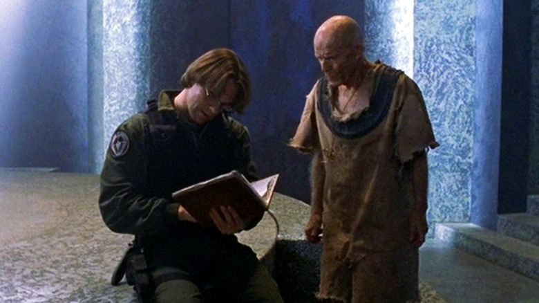 Daniel reading Ernest's journal as he watches in "Stargate SG-1"