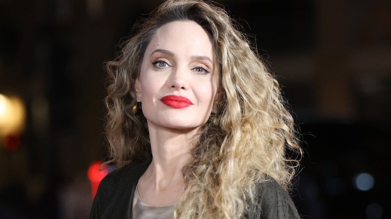 Angelina Jolie smiles with left shoulder slightly cocked