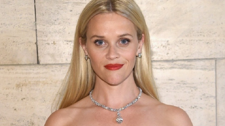 Reese Witherspoon poses in front of a wall