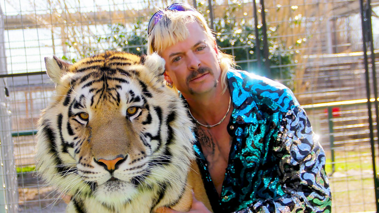 Joe Exotic in a cage with a tiger