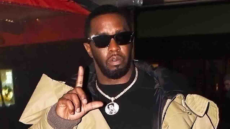 Sean Combs holding up an L sign