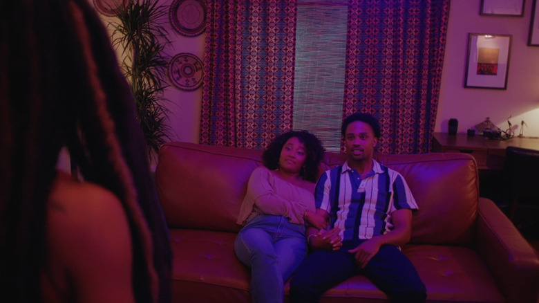 Jelani and Stacy on the couch looking at Lorraine in Three Ways (2022)