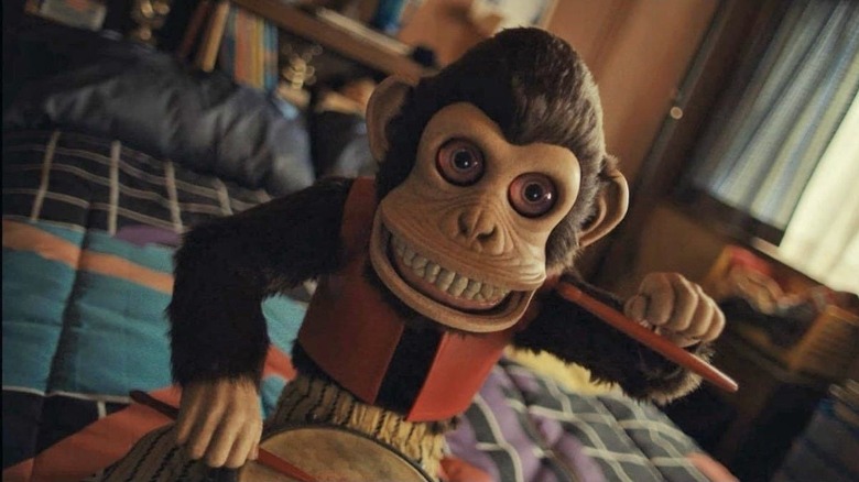 Toy monkey playing a drum in The Monkey