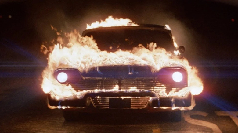 Christine burns with its headlights lit up in "Christine" (1983)