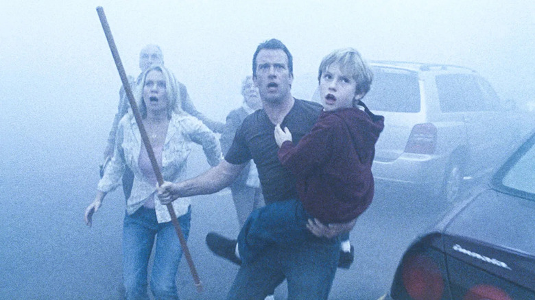 David Draydon holds Billy while leading fellow survivors as they look up in horror in "The Mist" (2007)