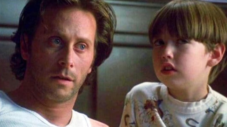 Jack Torrance sitting next to Danny in bed in The Shining (1997)