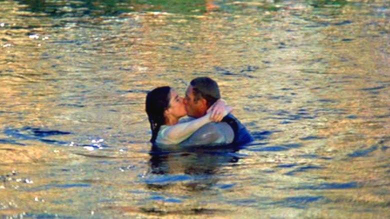Doc and Carol kissing in the water in "The Getaway"
