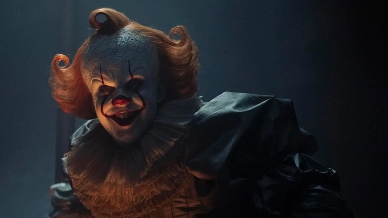Pennywise the clown smiles menacingly in IT: Welcome to Derry.