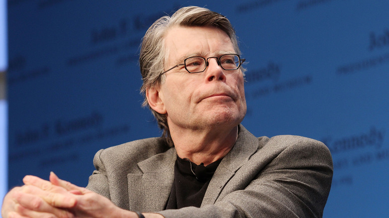 Stephen King listening at an event