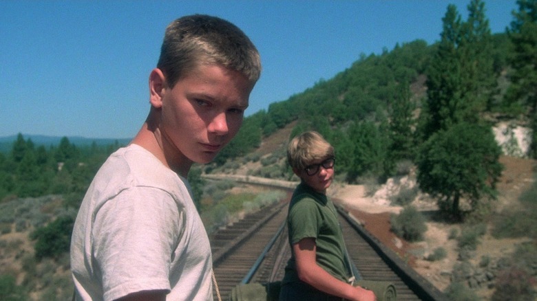 Chris and Teddy on railroad bridge glancing over their shoulders in "Stand By Me"