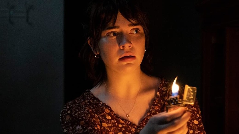 Sadie holding up a lit lighter in the dark in "The Boogeyman"