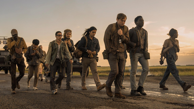 A group of young men walking down a road in 