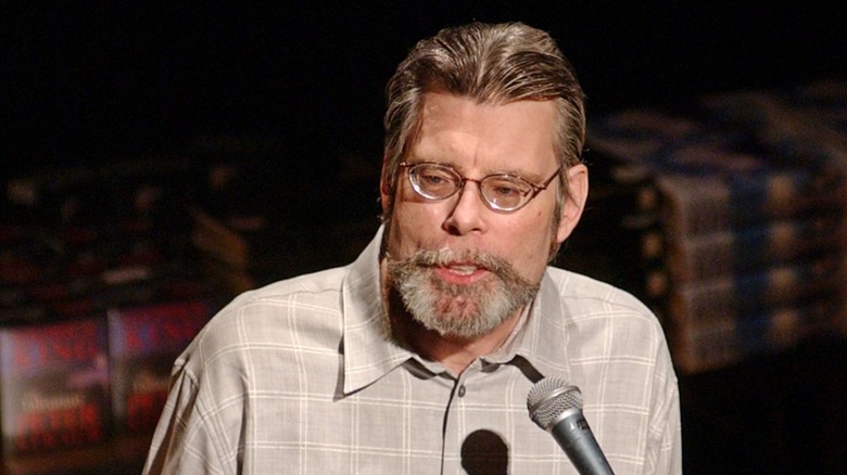 Stephen King speaking into a microphone onstage