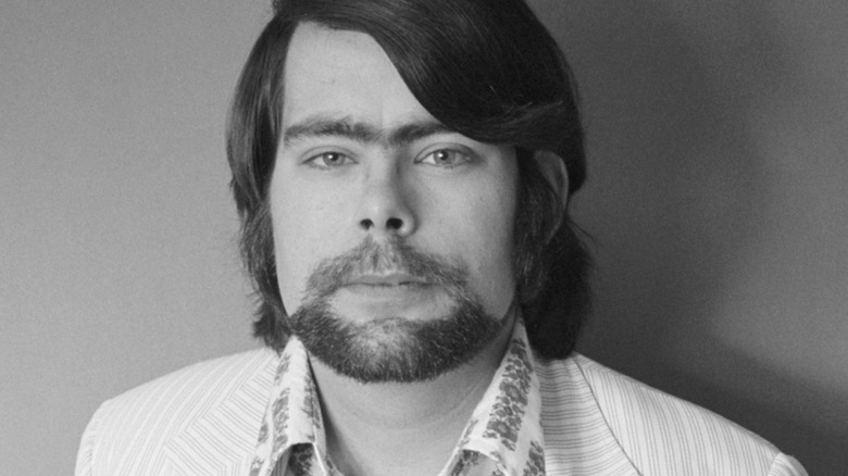 A black and white photo of Stephen King with a prominent unibrow