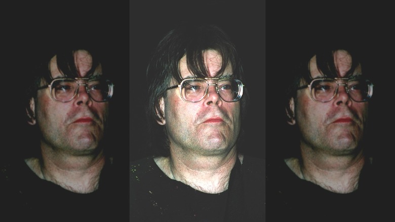 Stephen King with long hair and coke-bottle glasses, looking sad