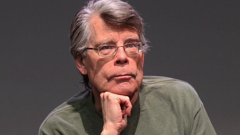 Stephen King looking thoughtful with his hand on his chin